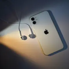 Biały iPhone 11 z słuchawkami, gotowy na premierę.