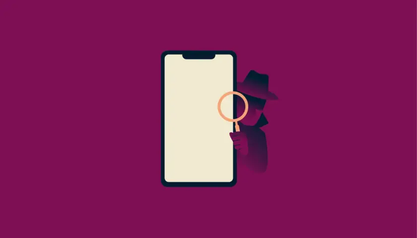 Detektyw z lupą bada smartfon. Dowiedz się, jak sprawdzić czy telefon jest na podsłuchu i chroń swoją prywatność.